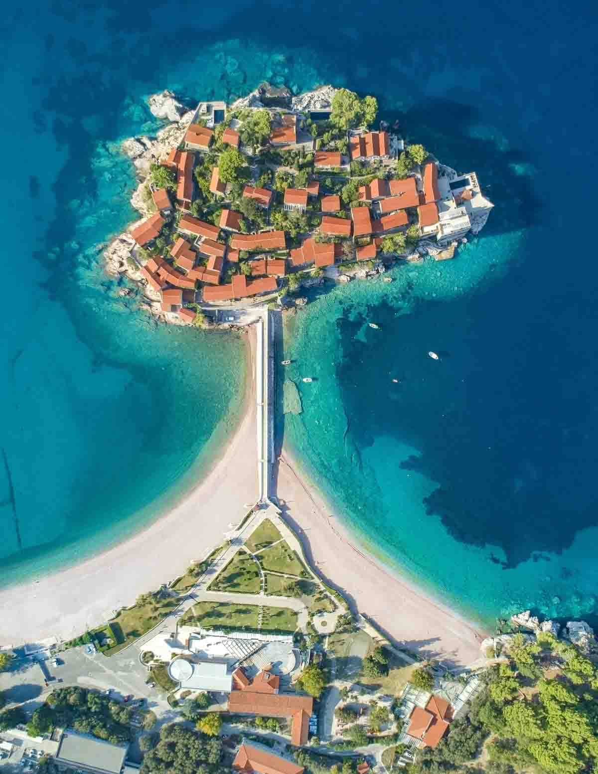 Aerial panorama of Sveti Stefan island, Budva with sea surrounding it.